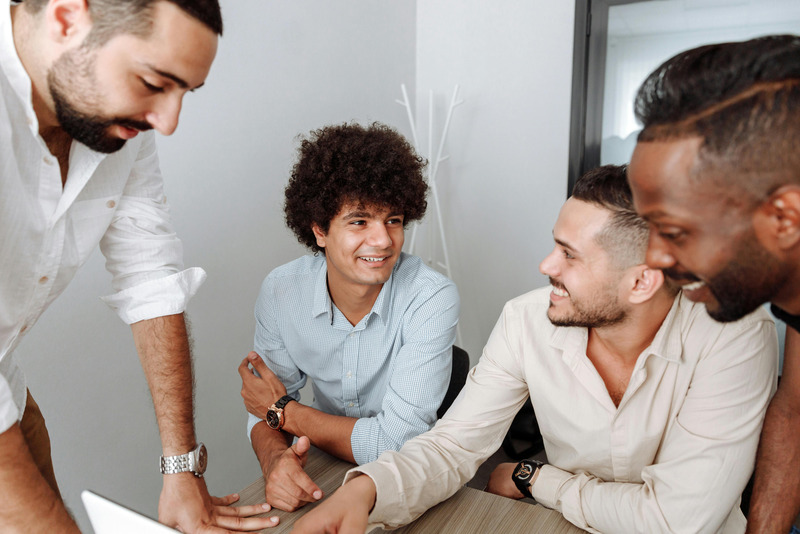 A small group in conversation around a table